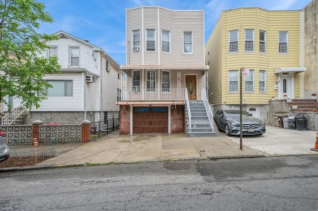 845 Kinsella St, Bronx, NY 10462 - view of front of property featuring stairway, driveway, a porch, an attached garage, and cooling unit