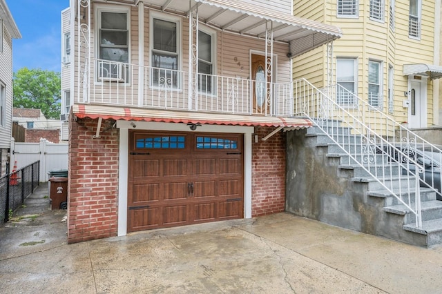 845 Kinsella St, Bronx, NY 10462 - view of front of home featuring a garage, concrete driveway, brick siding, and stairs