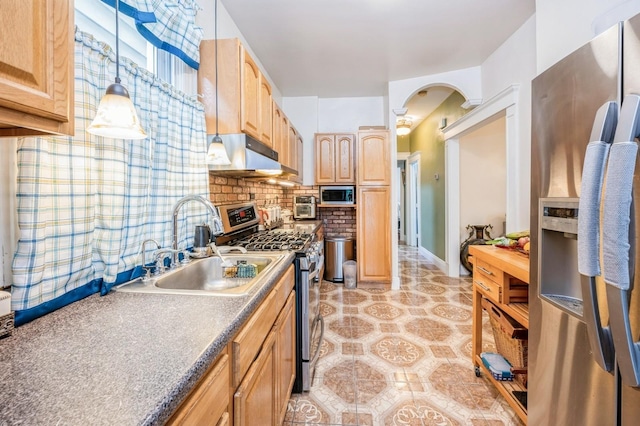 845 Kinsella St, Bronx, NY 10462 - kitchen with appliances with stainless steel finishes, under cabinet range hood, light brown cabinetry, arched walkways, and decorative backsplash