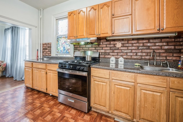 845 Kinsella St, Bronx, NY 10462 - kitchen with stainless steel gas stove, under cabinet range hood, dark countertops, and decorative backsplash