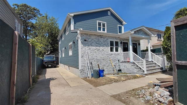 117-36 165th St, Jamaica, NY 11434 - view of front facade with concrete driveway and stone siding