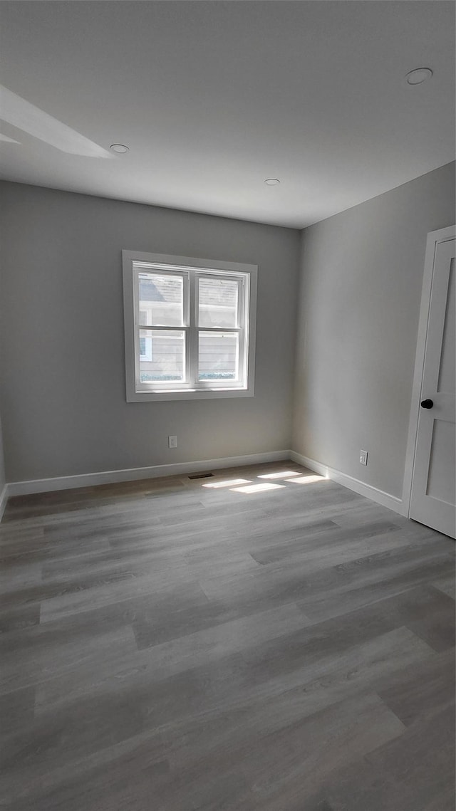 117-36 165th St, Jamaica, NY 11434 - spare room featuring baseboards and wood finished floors