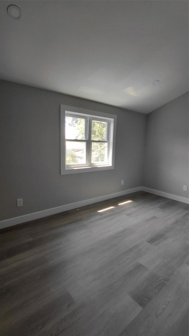 117-36 165th St, Jamaica, NY 11434 - unfurnished room with dark wood-style floors and baseboards