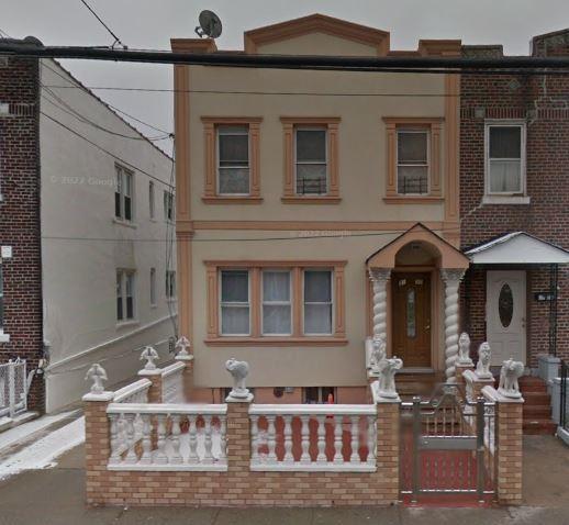 31-30 100th St, East Elmhurst, NY 11369 - multi unit property with a fenced front yard, stucco siding, and a gate
