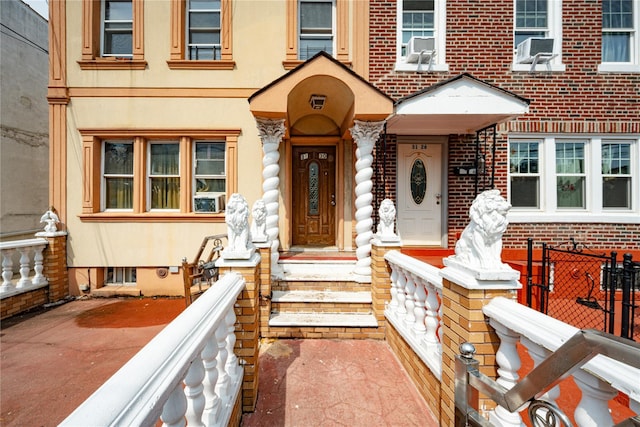 31-30 100th St, East Elmhurst, NY 11369 - property entrance featuring cooling unit and stucco siding