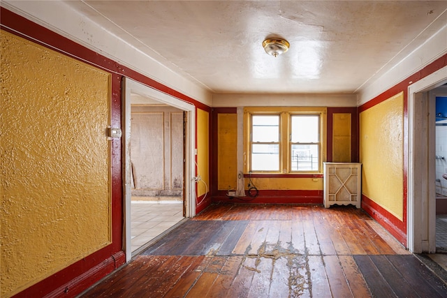 31-30 100th St, East Elmhurst, NY 11369 - empty room featuring wood-type flooring and a textured wall