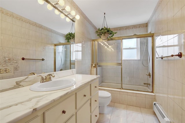 25-27 76th St, Jackson Heights, NY 11370 - bathroom with baseboard heating, tile walls, tiled shower / bath, vanity, and tile patterned floors