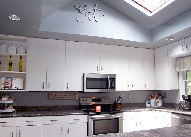 341 Thrift St, Ronkonkoma, NY 11779 - kitchen featuring appliances with stainless steel finishes, white cabinets, a skylight, dark stone counters, and recessed lighting