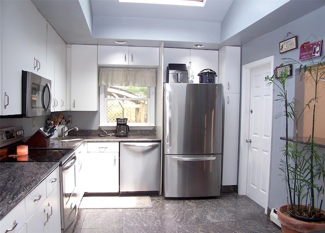 341 Thrift St, Ronkonkoma, NY 11779 - kitchen featuring stainless steel appliances, white cabinetry, and dark stone countertops