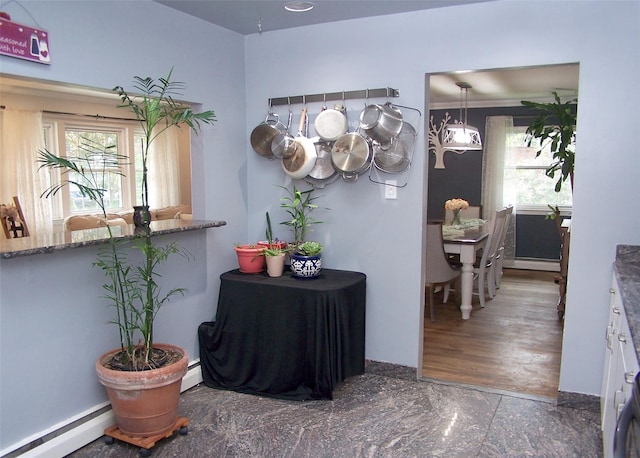 341 Thrift St, Ronkonkoma, NY 11779 - hallway featuring a baseboard heating unit and healthy amount of natural light