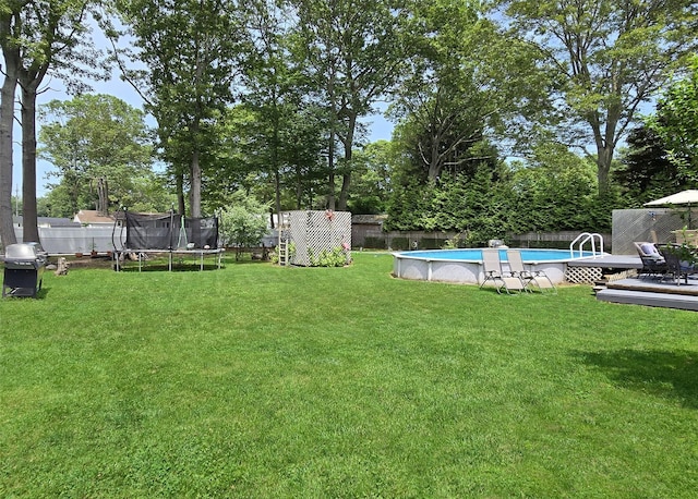 341 Thrift St, Ronkonkoma, NY 11779 - fenced backyard with a trampoline