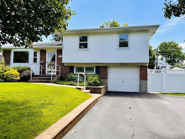 16 Warren Dr, Syosset, NY 11791 - tri-level home featuring brick siding, an attached garage, and asphalt driveway