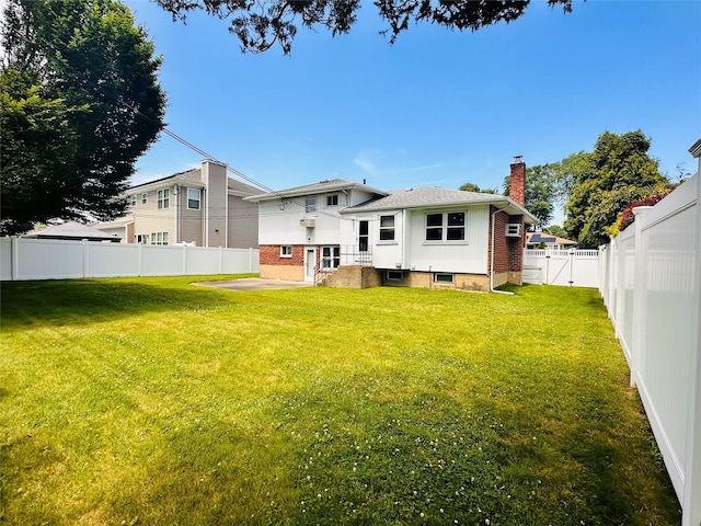 16 Warren Dr, Syosset, NY 11791 - back of house with a chimney, a fenced backyard, brick siding, a patio, and a gate