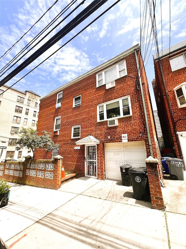 40-03 56th St, Woodside, NY 11377 - view of property featuring driveway and a garage