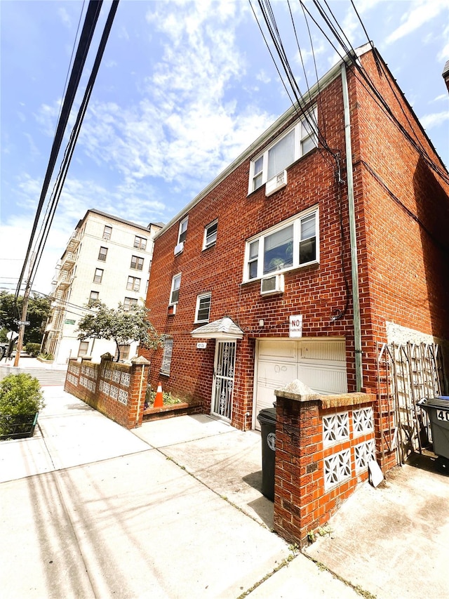 40-03 56th St, Woodside, NY 11377 - view of property with an attached garage and driveway