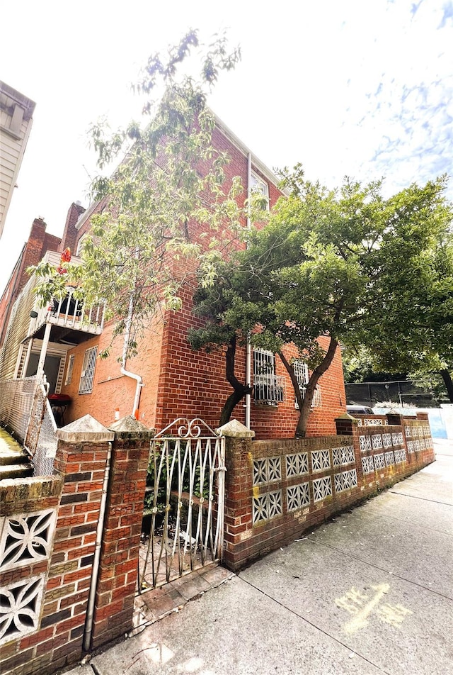 40-03 56th St, Woodside, NY 11377 - view of home's exterior with a gate and brick siding