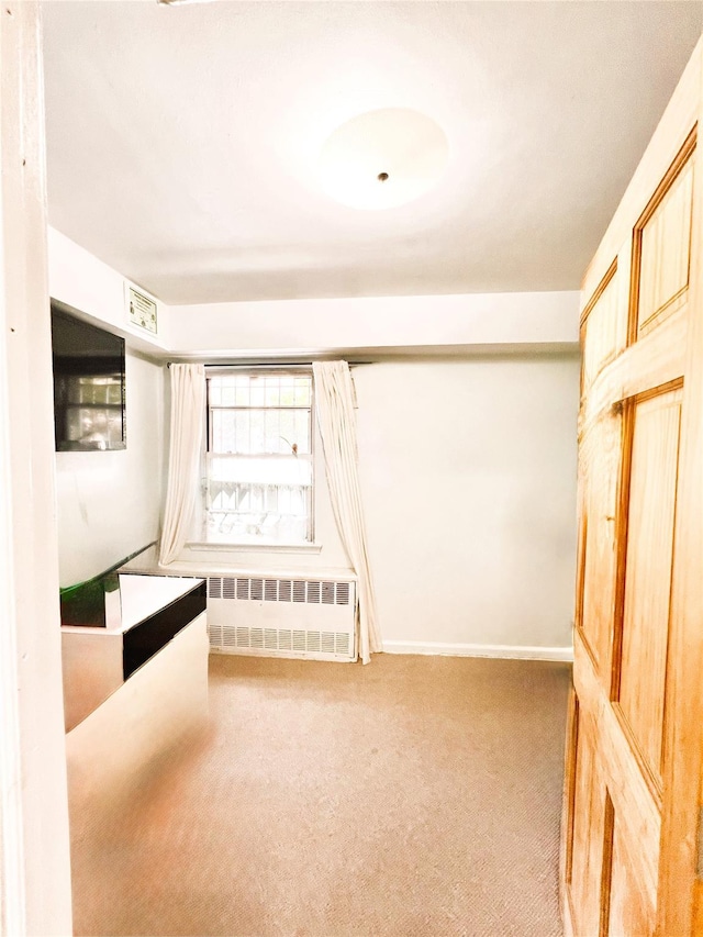 40-03 56th St, Woodside, NY 11377 - unfurnished bedroom featuring radiator and carpet floors