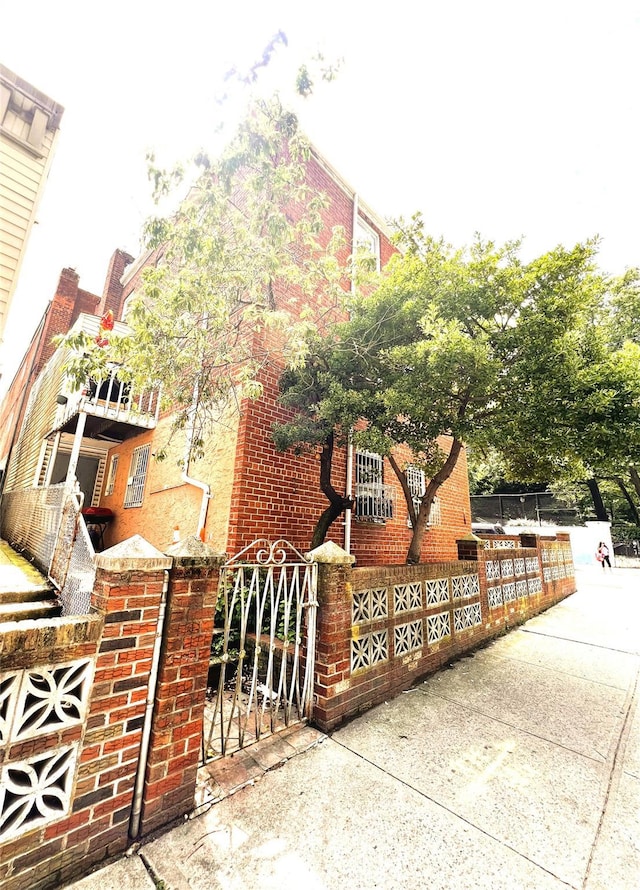 40-03 56th St, Woodside, NY 11377 - view of side of home with a gate and brick siding