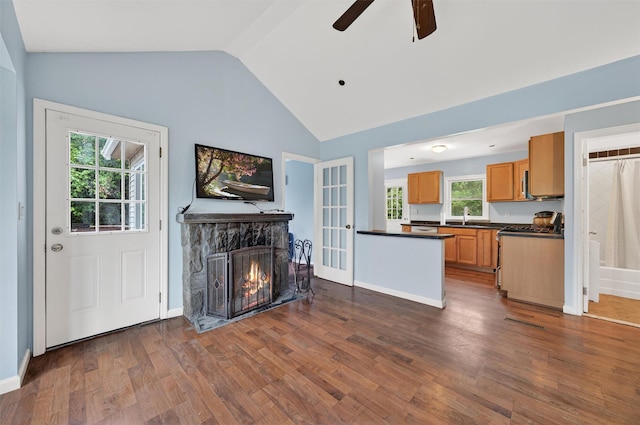 15 Claremont Trl, Monroe, NY 10950 - living area featuring lofted ceiling, a stone fireplace, ceiling fan, and dark wood-style flooring
