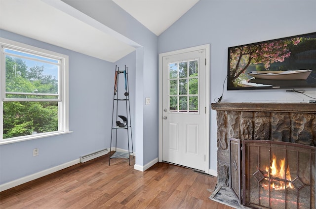 15 Claremont Trl, Monroe, NY 10950 - foyer featuring vaulted ceiling, a baseboard radiator, wood finished floors, and a fireplace