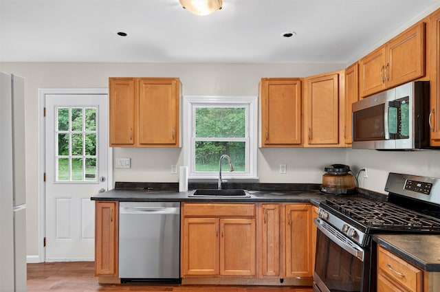 15 Claremont Trl, Monroe, NY 10950 - kitchen featuring appliances with stainless steel finishes, dark countertops, and light wood-style floors