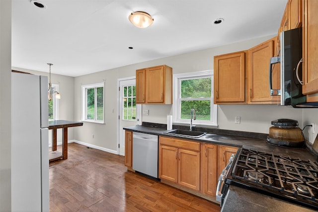 15 Claremont Trl, Monroe, NY 10950 - kitchen with stainless steel appliances, dark countertops, wood finished floors, and decorative light fixtures