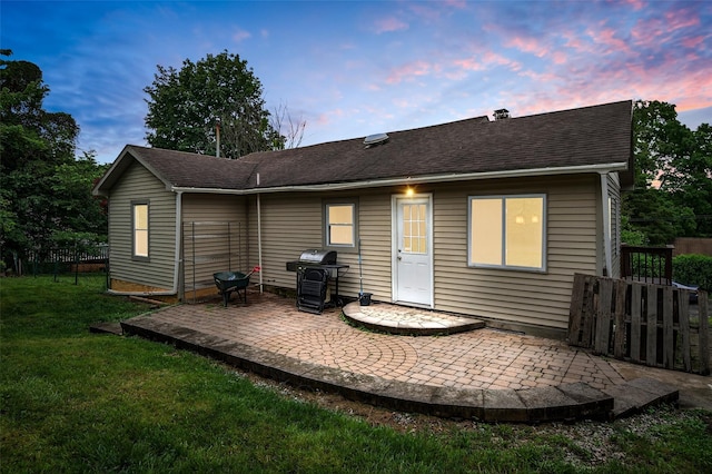15 Claremont Trl, Monroe, NY 10950 - back of property at dusk with a patio and roof with shingles