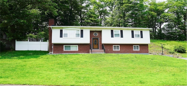 11 Boxwood Close, Hopewell Junction, NY 12533 - split foyer home with a chimney, brick siding, view of wooded area, and entry steps