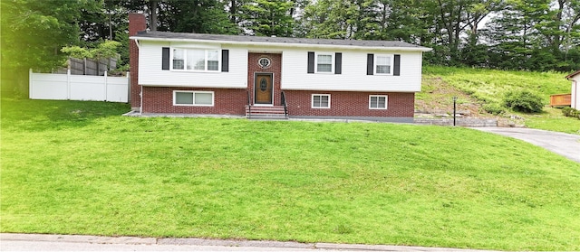 11 Boxwood Close, Hopewell Junction, NY 12533 - raised ranch featuring entry steps, brick siding, view of scattered trees, and a chimney