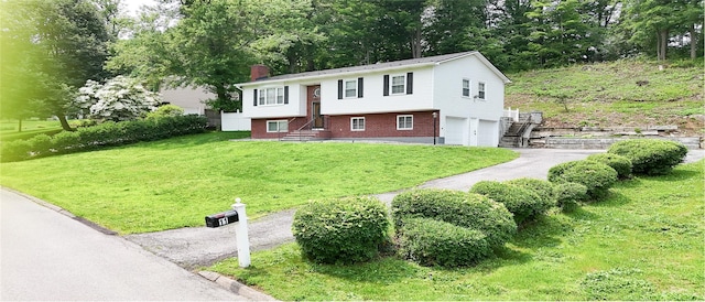 11 Boxwood Close, Hopewell Junction, NY 12533 - view of front of property with a chimney, a garage, asphalt driveway, and a front lawn