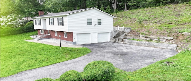 11 Boxwood Close, Hopewell Junction, NY 12533 - view of front of property featuring a chimney, driveway, stairway, a garage, and a front yard