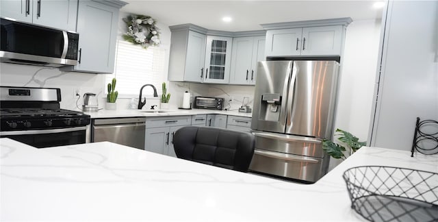 11 Boxwood Close, Hopewell Junction, NY 12533 - kitchen featuring appliances with stainless steel finishes, gray cabinets, light stone counters, recessed lighting, and glass insert cabinets