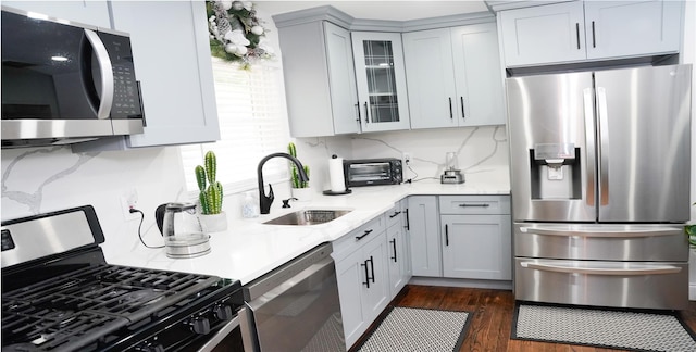 11 Boxwood Close, Hopewell Junction, NY 12533 - kitchen with appliances with stainless steel finishes, glass insert cabinets, tasteful backsplash, and dark wood-style floors