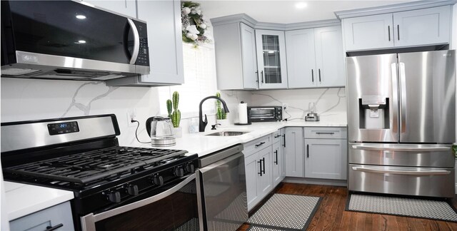 11 Boxwood Close, Hopewell Junction, NY 12533 - kitchen with stainless steel appliances, glass insert cabinets, dark wood finished floors, gray cabinetry, and recessed lighting