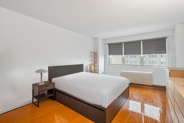 102-30 66th Rd Unit 5K, Forest Hills, NY 11375 - bedroom with light wood-style flooring and radiator heating unit
