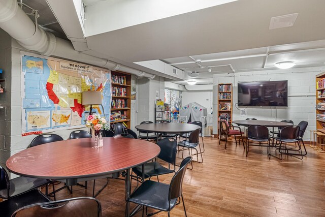 102-30 66th Rd Unit 5K, Forest Hills, NY 11375 - dining room with concrete block wall and light wood-style flooring