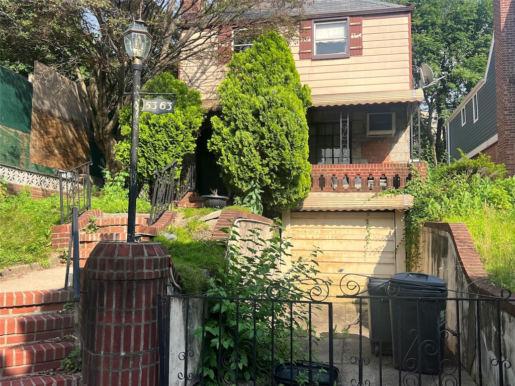 5363 63rd St, Maspeth, NY 11378 - view of front of house with a gate and brick siding