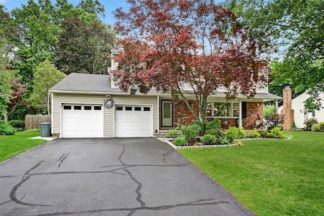 8 Argow Pl, Nanuet, NY 10954 - view of front facade with asphalt driveway, a front yard, and a garage