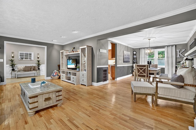 8 Argow Pl, Nanuet, NY 10954 - living area with light wood finished floors, a chandelier, a textured ceiling, crown molding, and recessed lighting