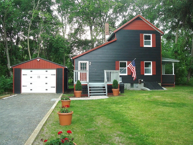 5 W Cottage Rd, Poughkeepsie, NY 12601 - view of front of home with an outbuilding, a chimney, driveway, a front yard, and a detached garage