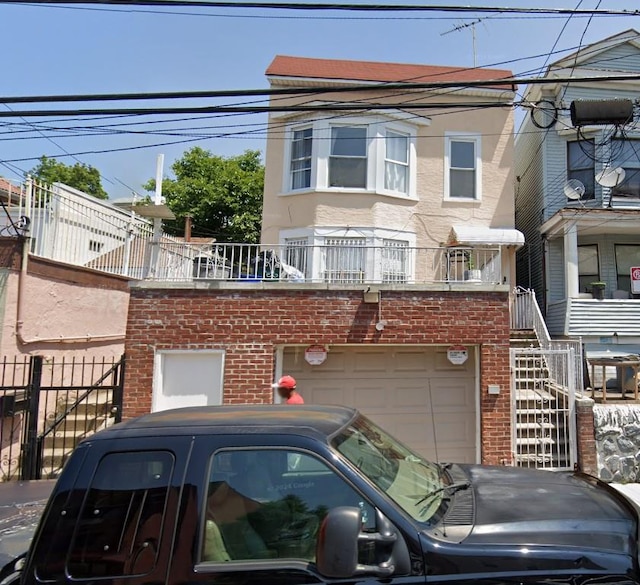 761 E 219th St, Bronx, NY 10467 - view of front facade with brick siding, an attached garage, and stucco siding