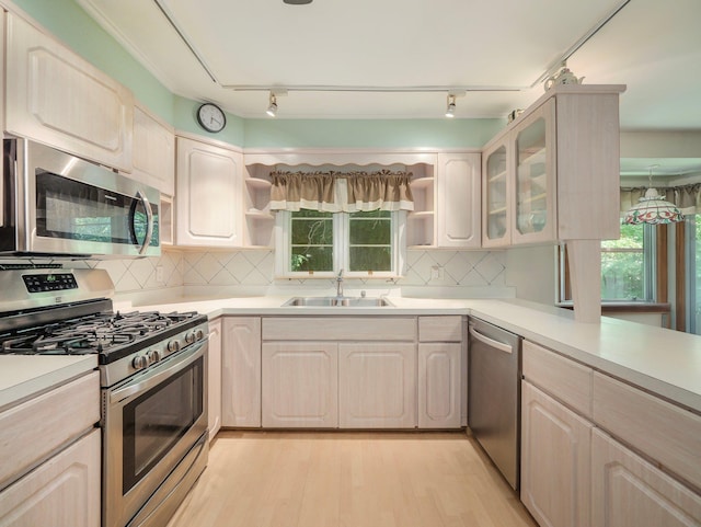 19 E Orchard St, Nanuet, NY 10954 - kitchen with appliances with stainless steel finishes, open shelves, light wood-type flooring, and light countertops