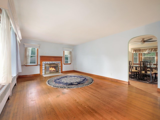 19 E Orchard St, Nanuet, NY 10954 - unfurnished living room featuring wood finished floors, ceiling fan, and a premium fireplace