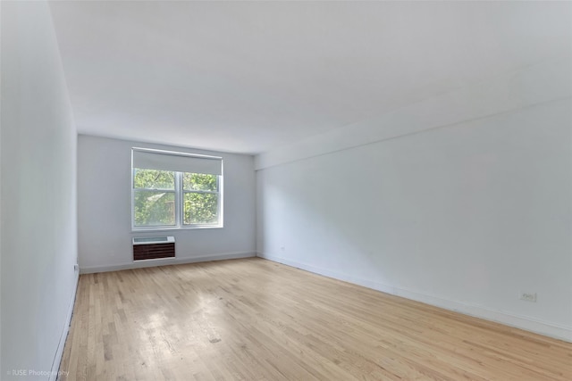 46-01 39th Ave Unit 303, Sunnyside, NY 11104 - empty room with wood finished floors and a wall mounted air conditioner