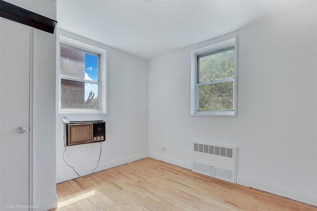 46-01 39th Ave Unit 303, Sunnyside, NY 11104 - unfurnished room featuring radiator heating unit and wood finished floors