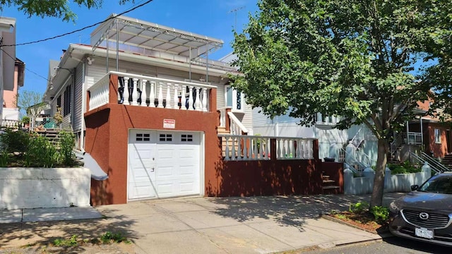 9-24 College Point Blvd, College Point, NY 11356 - view of front of home featuring a garage, driveway, and stairway