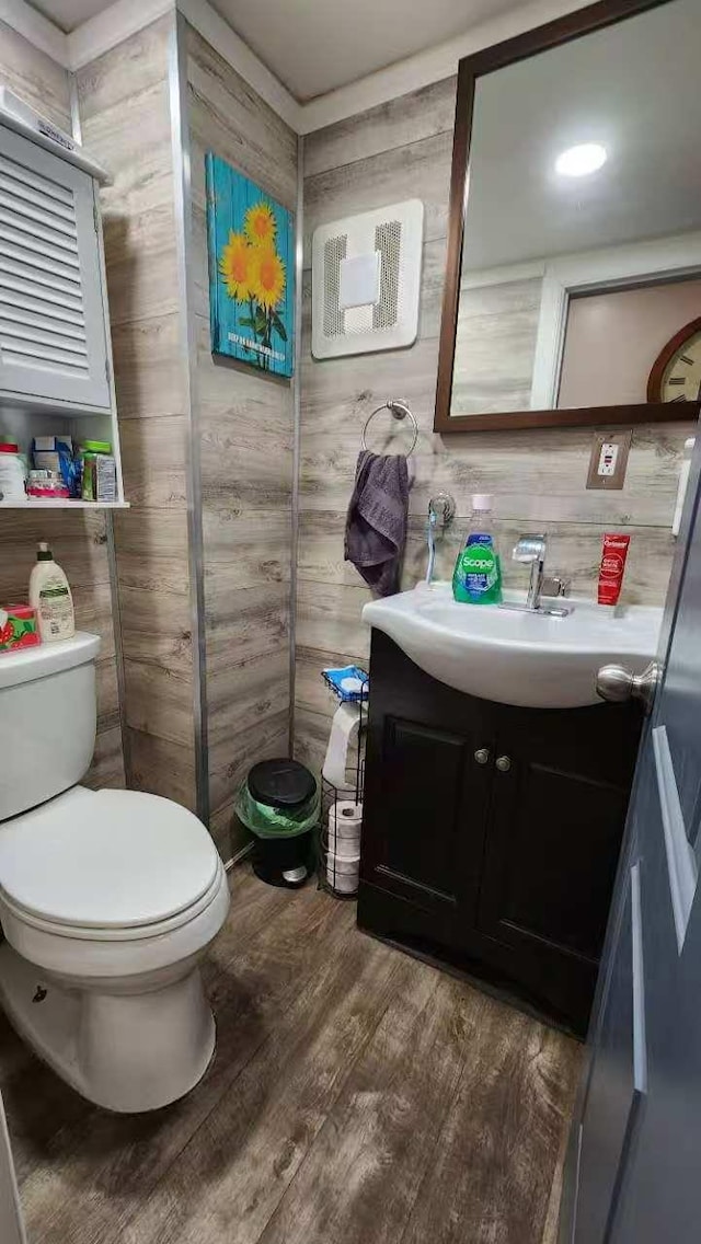 9-24 College Point Blvd, College Point, NY 11356 - half bathroom featuring vanity, wood finished floors, and wood walls