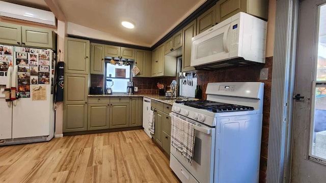 9-24 College Point Blvd, College Point, NY 11356 - kitchen featuring white appliances, light wood-style floors, backsplash, light stone counters, and vaulted ceiling