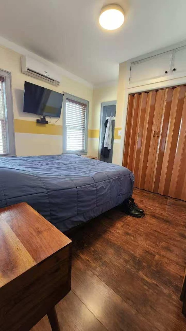 9-24 College Point Blvd, College Point, NY 11356 - bedroom featuring a wall unit AC and wood finished floors