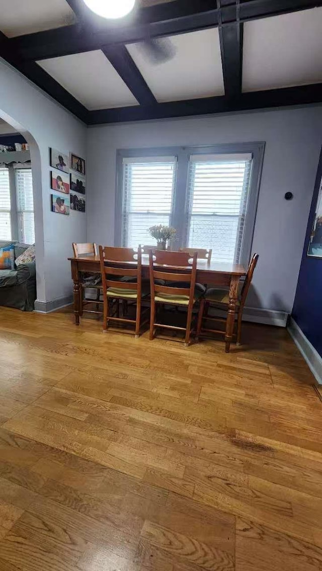 9-24 College Point Blvd, College Point, NY 11356 - dining space featuring coffered ceiling, arched walkways, light wood finished floors, and beamed ceiling